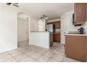 Bright kitchen area with tiled floor, wood cabinets, granite countertops, and stainless steel appliances at 5839 Meadowpark Pl, Lithia, FL 33547