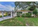 Charming single-story home with a well-manicured lawn and covered carport, perfect for Florida living at 629 Lexington St, Dunedin, FL 34698