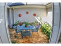 Private courtyard with an outdoor dining area surrounded by lush greenery and decorative wall art, creating a serene ambiance at 6820 Muncaster Ct, Tampa, FL 33625