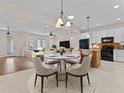 Bright dining area with a modern chandelier, and an open view to the kitchen and living room at 6820 Muncaster Ct, Tampa, FL 33625