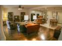 Inviting living room that offers an open-concept layout with hardwood floors, seamlessly connecting to the kitchen and dining areas at 6820 Muncaster Ct, Tampa, FL 33625