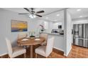 Charming dining area with breakfast bar, stainless steel appliances, and wood-look flooring at 714 1St Ct, Palm Harbor, FL 34684