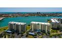 A scenic view of waterfront condos overlooking tranquil blue waters and city in the distance at 7872 Sailboat Key S Blvd # 301, South Pasadena, FL 33707