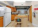 The communal kitchen is equipped with a stovetop, stainless steel hood, and refrigerator at 7910 Hardwick Dr # 717, New Port Richey, FL 34653