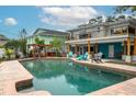 Inviting backyard pool area featuring brick coping, lounge chairs, and outdoor grilling and seating at 854 77Th N Ave, St Petersburg, FL 33702