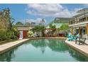 Backyard swimming pool surrounded by brick coping, lounge chairs, and lush landscaping at 854 77Th N Ave, St Petersburg, FL 33702