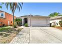 Charming single-Gathering home featuring a two-car garage and well-manicured lawn, perfect for Gathering living at 8736 Huntfield St, Tampa, FL 33635