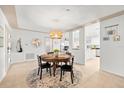 Cozy dining area features a round table, pendant light, and seamless flow to kitchen at 8848 Sunlit Cove Ne Dr, St Petersburg, FL 33702
