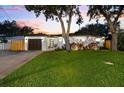 Charming single-story home featuring lush green lawn, manicured landscaping, and a freshly painted exterior at 8848 Sunlit Cove Ne Dr, St Petersburg, FL 33702