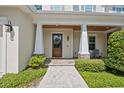 Inviting front entrance featuring a wood door, stone pillars, and well-maintained landscaping at 911 S Sterling Ave, Tampa, FL 33629