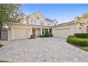 Charming home with a three-car garage and beautiful brick driveway, complemented by lush landscaping at 911 S Sterling Ave, Tampa, FL 33629
