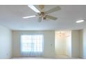 Bright living room offering ceiling fan and windows with view of a large backyard at 106 Silverbell Ct, Sun City Center, FL 33573