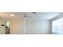 Bright living room featuring neutral paint, ceiling fan, and natural light from large windows at 106 Silverbell Ct, Sun City Center, FL 33573