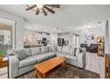 Open-concept living area features a spacious sofa and a view of the modern kitchen at 11322 Lake Lucaya Dr, Riverview, FL 33579