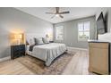 Serene main bedroom with a ceiling fan, wood-look flooring and bright window light at 11322 Lake Lucaya Dr, Riverview, FL 33579