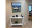 Entryway features beach themed decor, including a boat painting and white console table at 1200 Gulf Blvd # 404, Clearwater Beach, FL 33767