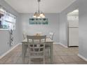 Bright dining area with a white table and chairs, adjacent to the kitchen at 12760 Indian Rocks Rd # 578, Largo, FL 33774