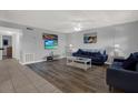 Cozy living room featuring hardwood floors, neutral walls, and comfortable blue seating at 12760 Indian Rocks Rd # 578, Largo, FL 33774