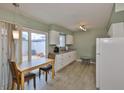 Bright kitchen featuring modern appliances, tile flooring and a breakfast nook with sliding glass doors at 1304 Burbank Ct, Sun City Center, FL 33573