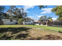 Well-maintained backyard with manicured lawn, a custom cabana, and newer fencing at 1357 S Betty Ln, Clearwater, FL 33756