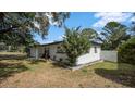 Well-maintained single story home featuring lush landscaping with mature trees at 1357 S Betty Ln, Clearwater, FL 33756