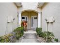 Front entrance to townhouses featuring decorative columns and landscaping at 14985 Alan Ct, Largo, FL 33771