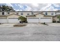 Street view of three townhouses, each with a two-car garage at 14985 Alan Ct, Largo, FL 33771