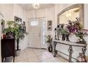 Bright foyer with tile floors, decorative mirror, and a colorful flower arrangement at 14985 Alan Ct, Largo, FL 33771