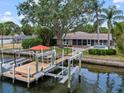 Waterfront home with private dock, boat lift, screened lanai, and sparkling pool at 150 Carlyle Dr, Palm Harbor, FL 34683