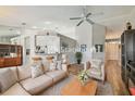 Comfortable living room with neutral decor, plush seating, wood flooring, and open to kitchen at 1758 Biarritz Cir, Tarpon Springs, FL 34689
