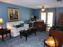 Spacious living room featuring stylish furniture, a patterned rug, and neutral-toned walls at 2025 Dover Ct, Oldsmar, FL 34677