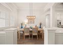 Bright dining room featuring decorative lighting, white walls, and views to the main living area at 2142 Scarlet Oaks St, Clearwater, FL 33759