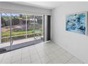 Screened-in patio offering seamless indoor-outdoor living with views of the well-maintained backyard at 2413 Oxford Down Ct # 58, Sun City Center, FL 33573