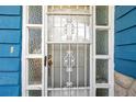Front door with security features and decorative glass inserts at 3621 Beacon Square Dr, Holiday, FL 34691