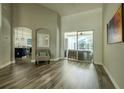 Spacious living room featuring hardwood floors, neutral paint, and ample natural light from sliding glass doors at 4612 River Overlook Dr, Valrico, FL 33596