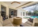Inviting covered patio with comfortable seating and view of the pool and spa at 4612 River Overlook Dr, Valrico, FL 33596