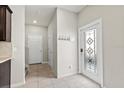 Bright entryway featuring decorative glass door and tile flooring leading to the staircase at 5344 Sylvester Loop, Tampa, FL 33610