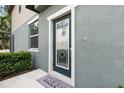 Front entrance featuring a decorative glass door and a 'Hello' welcome mat at 5344 Sylvester Loop, Tampa, FL 33610