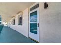 Exterior of unit 503 with a screen door and sidelight window plus a view of the corridor at 6020 Shore S Blvd # 503, Gulfport, FL 33707