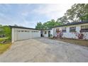 Charming home features a two-car garage and a well-maintained front yard with mature landscaping at 6603 Oakview Ter, Tampa, FL 33610