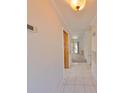 Bright hallway featuring tile flooring that leads into a spacious room with outdoor views at 6603 Oakview Ter, Tampa, FL 33610