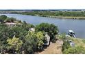 Aerial view showcasing the waterfront home with private dock and lush landscaping on the Palm River at 6610 Myrna Dr, Tampa, FL 33619