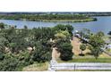 Aerial view of a waterfront property with lush greenery and direct water access at 6610 Myrna Dr, Tampa, FL 33619