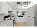 Bright kitchen with stainless steel appliances, ample countertop space, and well-lit cabinets, perfect for cooking at 9607 Brassie Ct # 9607, New Port Richey, FL 34655