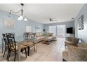 Open-concept living and dining area, with large windows offering plenty of natural light and comfortable seating arrangements at 9607 Brassie Ct # 9607, New Port Richey, FL 34655