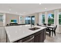 Spacious kitchen with quartz countertops, large island, and stainless steel dishwasher at 10379 Bridgegate Heights Loop, San Antonio, FL 33576