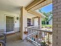 Inviting front porch with decorative columns, garden accents, and seating area at 10520 Tapestry Dr, Port Richey, FL 34668