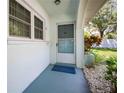 Welcoming front porch with a blue door, showcasing the home's exterior details and landscaping at 11200 102Nd Ave # 62, Seminole, FL 33778