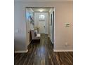 Bright entryway featuring hardwood floors and a charming bench, creating a warm welcome at 11617 Brighton Knoll Loop, Riverview, FL 33579