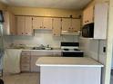 Functional kitchen featuring ample cabinetry, laminate countertops, and essential appliances for everyday cooking at 1204 W Alsobrook St, Plant City, FL 33563